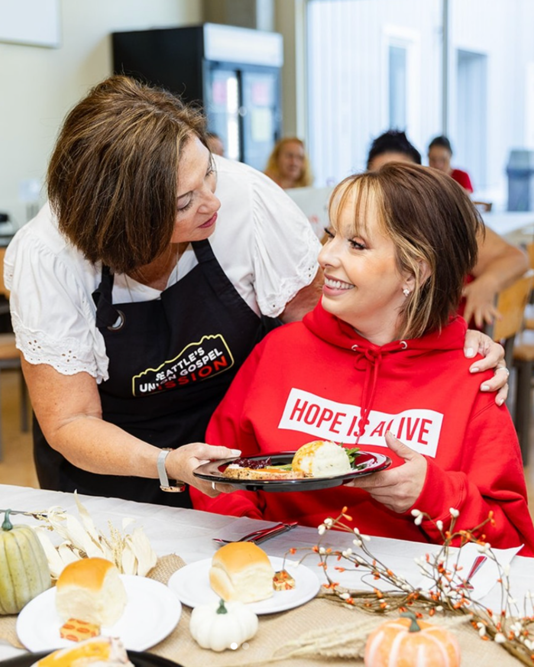 Seattles Union Gospel Mission volunteer staff serving food to a client